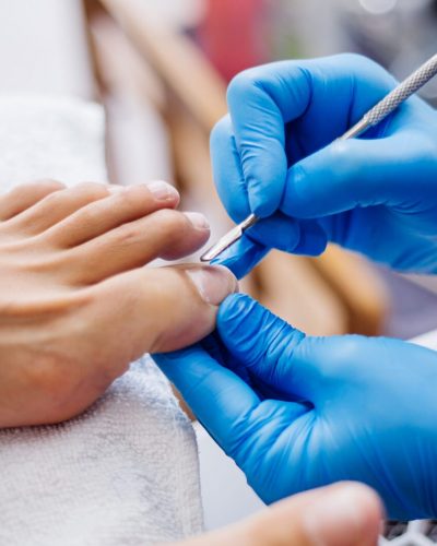 pedicure-process-home-salon-pedicure-foot-care-treatment-and-nail-the-process-of-professional-pedicures-master-in-blue-gloves-make-pedicure